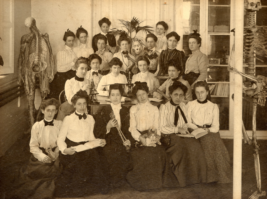sepia toned photo of women in a classroom in 1903