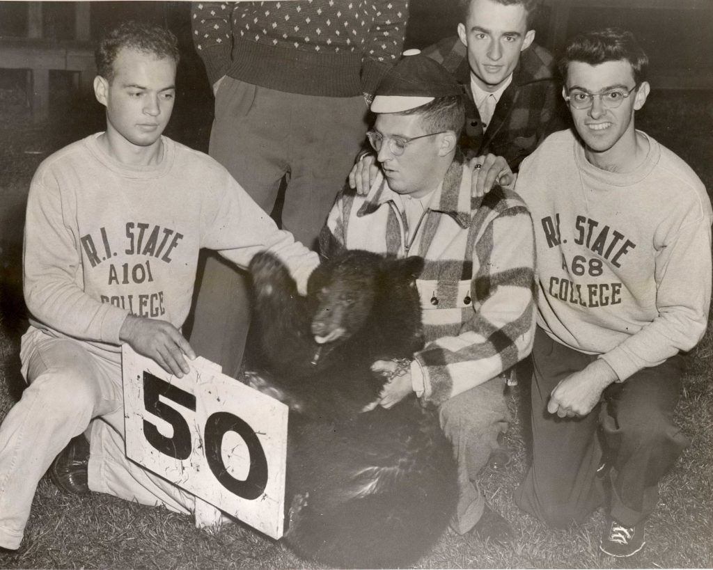 Rhode Island State students posing with the captured Brown mascot, Bruno X, in 1949