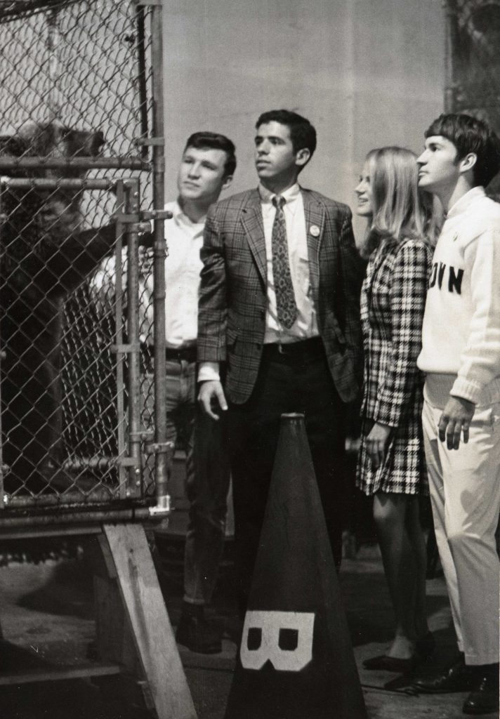 students watching a live bear in cage