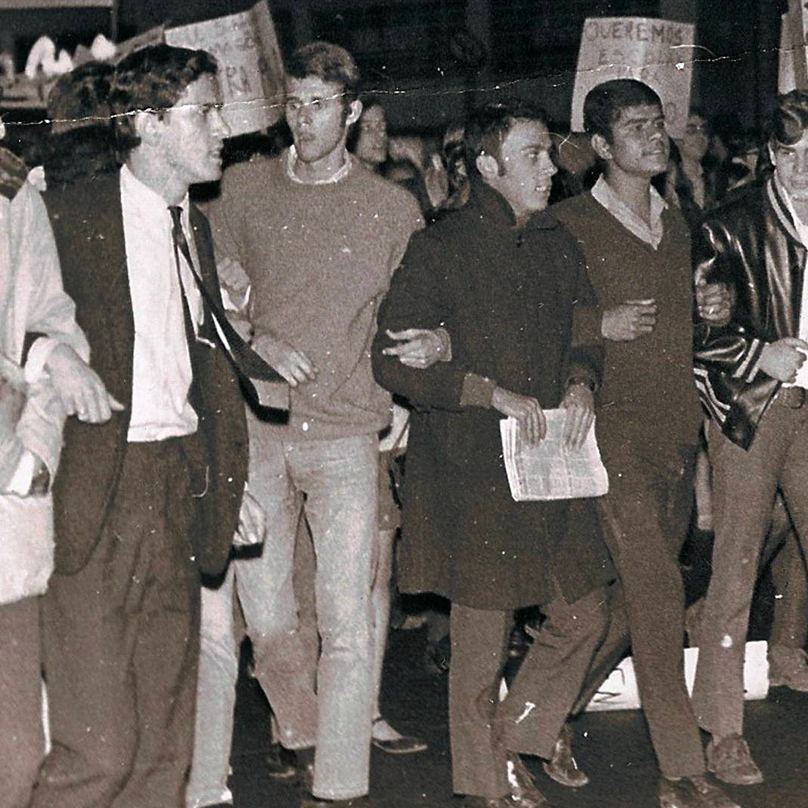 a group of young protesters linking arms