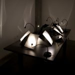 work table with several reading lamps, each trained on a piece of paper