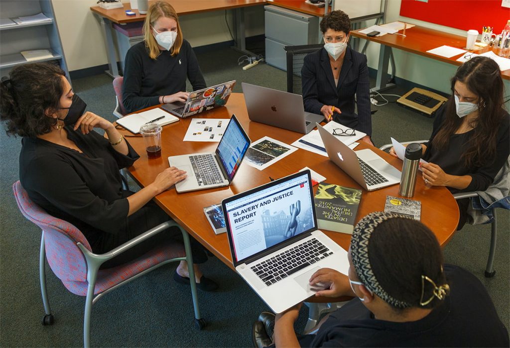 Brown University Digital Publications staff seated together and working around a table