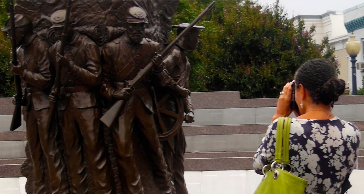 Professor Renee Ater photographing a monument