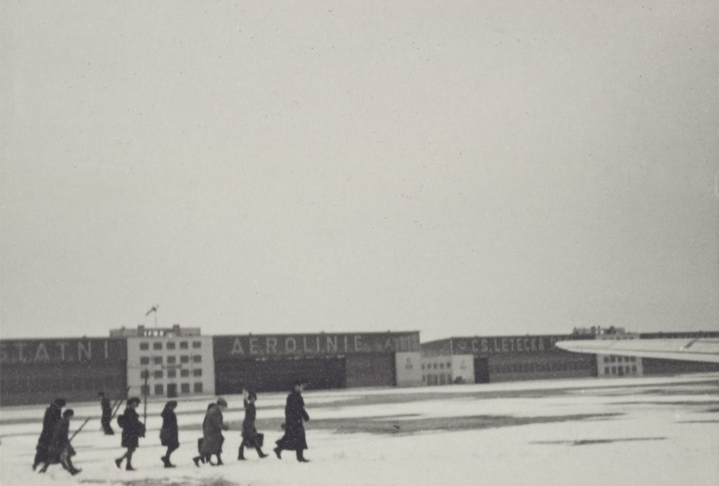 Rev. Waitstill and Martha Sharp leading adults and children to an airplane in Czechoslovakia, 1939.