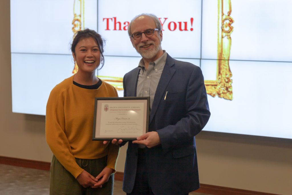 Maya Omari receives award certificate