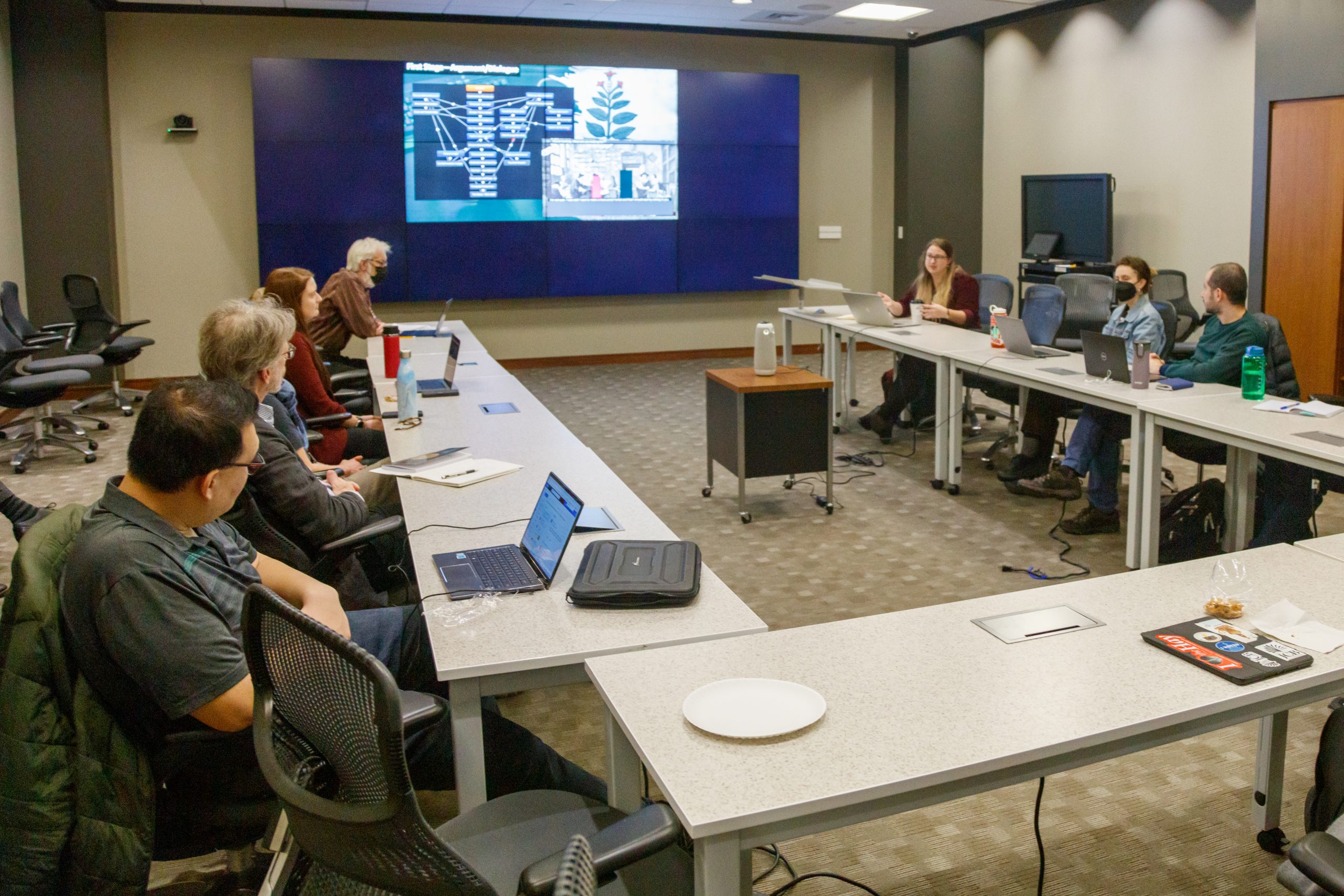 people in room with screen