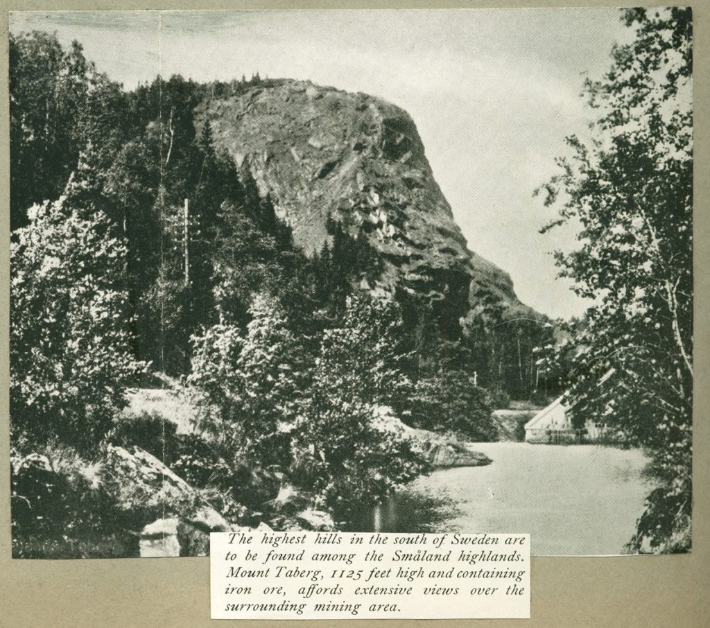 Black and white photo of Mount Taberg from a scrapbook documenting astronomer Charles H. Smiley's travels in Sweden during 1954, with a description on the photo that reads "The highest hills in the south of Sweden are to be found among the Smaland highlands. Mount Taberg, 1125 feet high and containing iron ore, affords extensive views over the surrounding mining area."