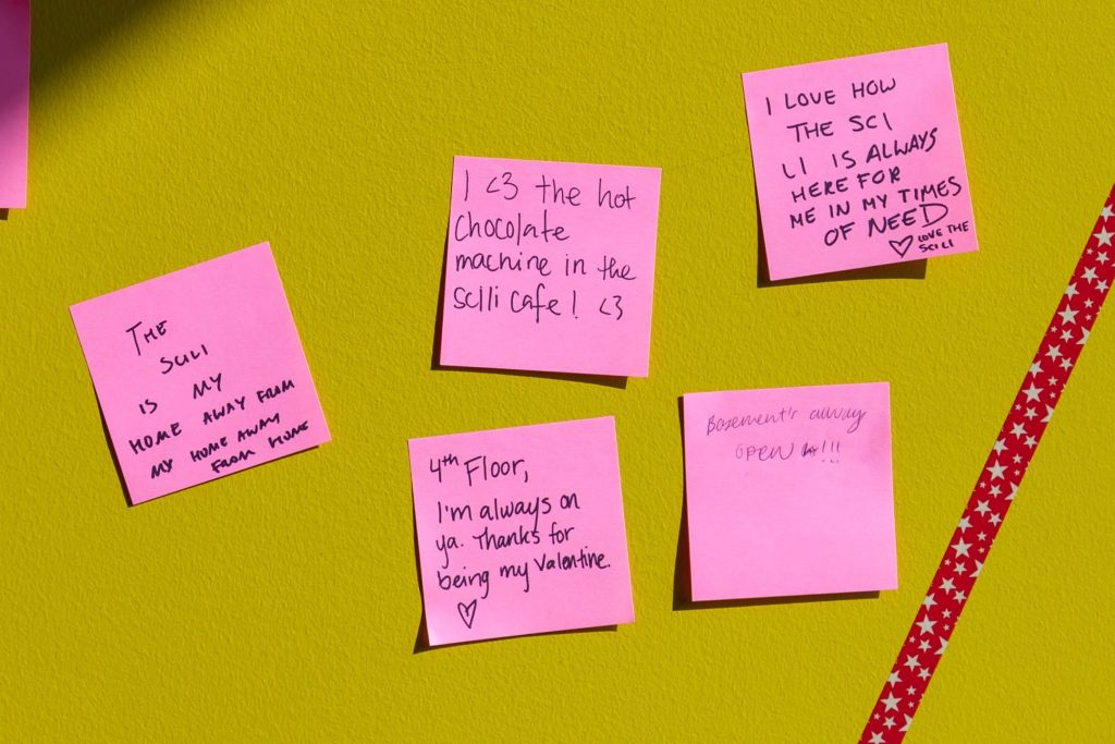 photo of pink sticky notes filled out by students during #LibraryLove event