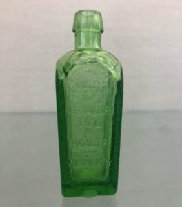 Small vintage green glass reproduction bottle for Straubmuller's Elixir embossed with "Nectar of the Golden Life of Health and Vitality".