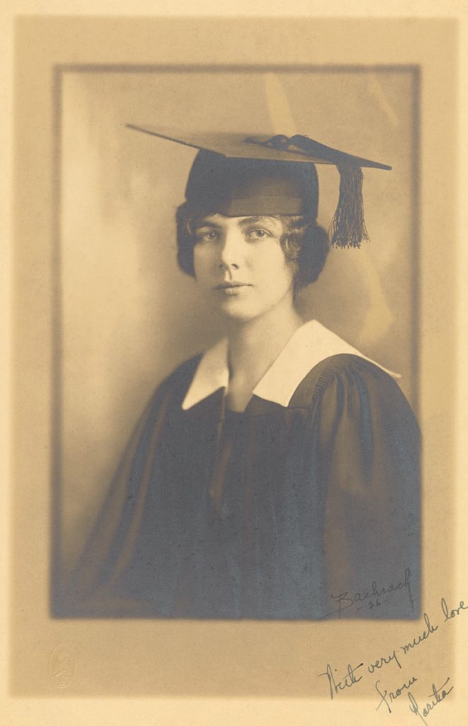 black and white image of woman in graduation cap and gown
