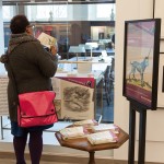 Colloquium atttendee viewing exhibit