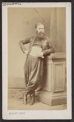 Cartes-de-visite were commonly traded among friends and visitors in the 1860s. The albums that collected and displayed these cards became a common fixture in Victorian parlors. Their relatively low cost contributed to the popularity of the format and its rapid adoption worldwide, which made portrait photographs accessible to a broader demographic. The cards also made the ideal way to remember loved ones fighting in foreign wars, making soldiers frequent clients at photography studios. Prior to the advent of mechanical reproduction of photographs, cartes-de-visite facilitated the dissemination and collection of portraits of prominent persons as an early form of celebrity culture. It is uncertain whether these photographs were given as personal portraits between familiars or as character types of ethnic groups serving in the French Army, which was also a common use of these carte-de-visite, akin to earlier costume album paintings.

All of these cartes-de-visite feature Zouave uniforms, yet only the one portraying Turcos was definitively photographed by a studio in Algiers. Part of the appeal of this cross-cultural uniform was how intentionally difficult it became to discern the ethnic origins of a soldier with certainty (though the titles tirailleurs and turcos often indicated troops of North African descent). Likewise, the popularity of Zouave soldiers — and the women who served as cantinières, or canteen keepers, and who sometimes fought alongside them in battle — spurred many French consumers and performers, including female burlesque dancers, to dress in Zouave costumes for studio portraits. Though a highly exoticizing use of regional fashion, the rising numbers of commercial portraits of civilians donning Zouave costumes attest to how these soldiers and the visual traces of colonization had infiltrated the popular imaginations of French consumers.