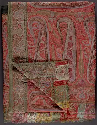 As early as 1750, the BEIC imported “India shawls” (cashmere) from Bombay and other Indian ports. The accessories rapidly spread across Europe and America after Napoleon’s expedition into Egypt in 1798–99, after officers brought home samples of imported Indian shawls worn in this Ottoman territory. These shawls arrived in America on New England trade ships coming from Ottoman Smyrna and beyond. Though India trade diminished somewhat in the nineteenth century, Godey’s Lady’s Book (May 1858) still featured luxury Indian shawls, estimating that an authentic full-size shawl cost from $500 to $5,000, with heavy customs duties. Many combine embroidery, loomwork, and sections of needlework carefully arranged in patterns sewn together. These shawls were frequently associated with rajahs and sultans in women’s periodicals throughout the Indian Uprising of 1857–58, and these world events seemed to enhance their exotic appeal. They inspired cheaper imitations made in France and England then imported to the United States.